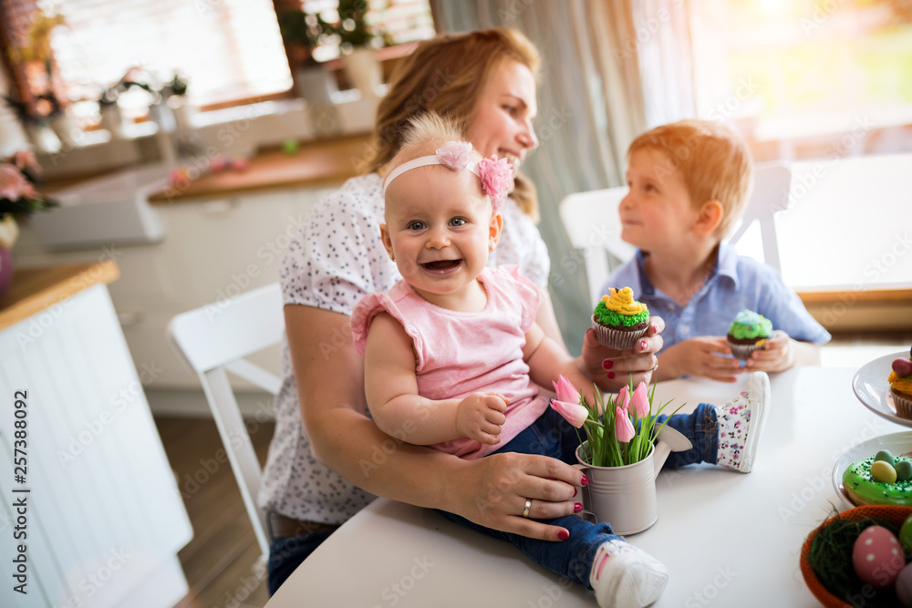 Happy easter. A mother and her kids painting Easter eggs Happy easter. A mother and her kids painting Easter eggs