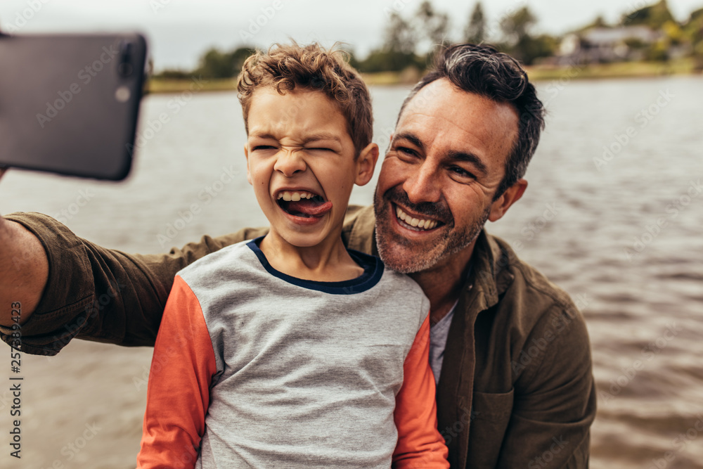 Father and son taking a selfie Father and son taking a selfie