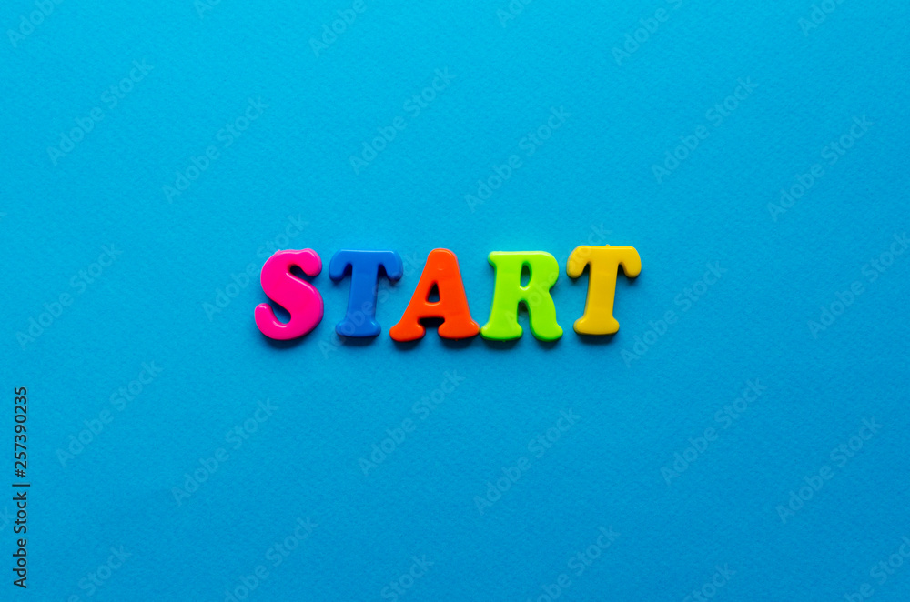 text start from plastic colored letters on blue paper background text start from plastic colored letters on blue paper background