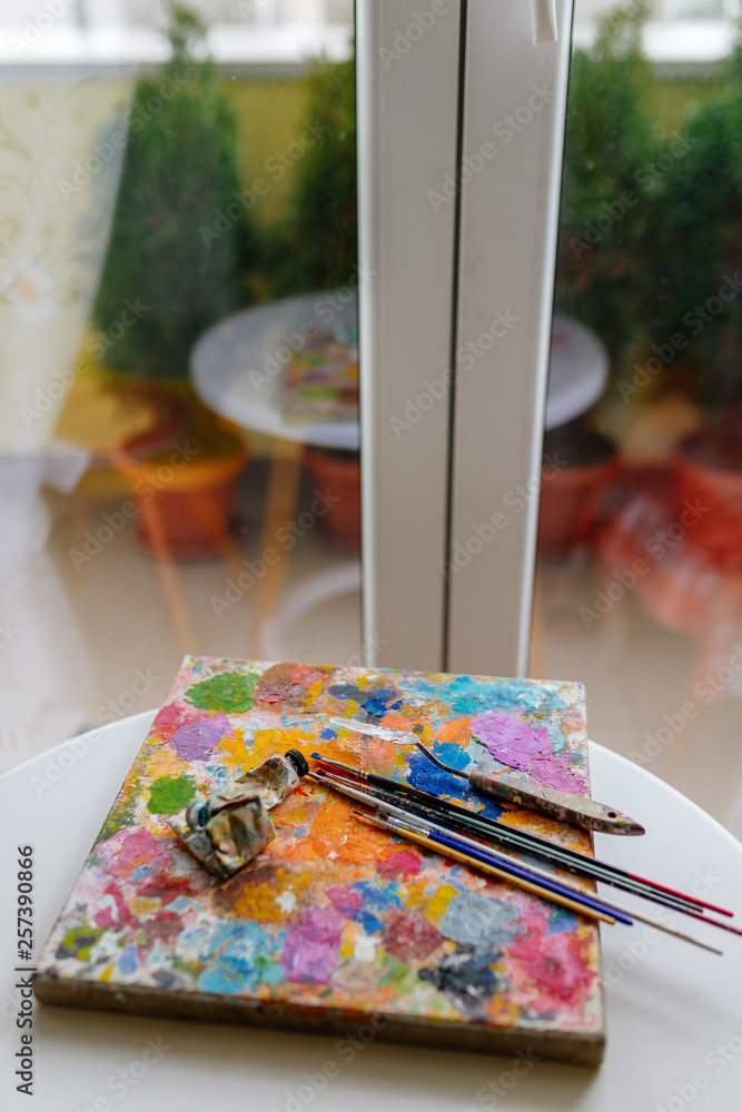 Artistic paint brushes and palette in the studio Artistic paint brushes and palette in the studio