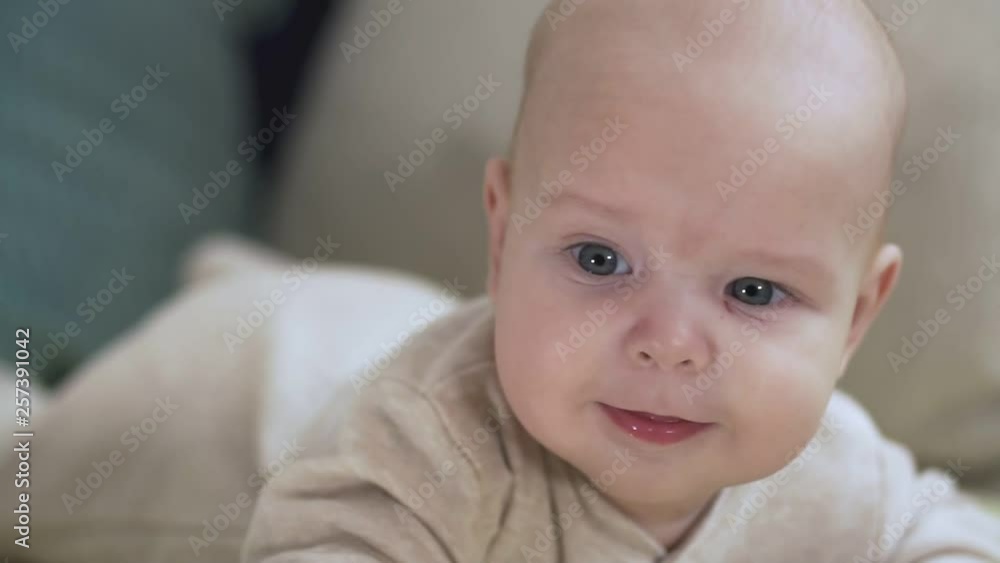 Close up of baby luying on bed. Childhood, babyhood and people concept. Close up of baby luying on bed. Childhood, babyhood and people concept.