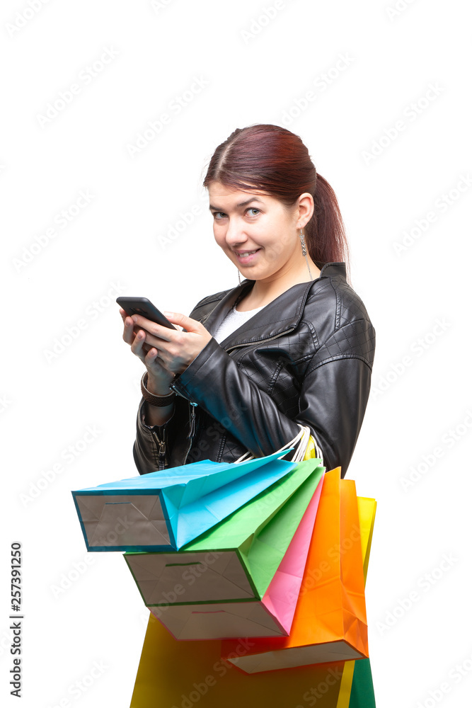 Happy young woman with shopping bags and phone Happy young woman with shopping bags and phone