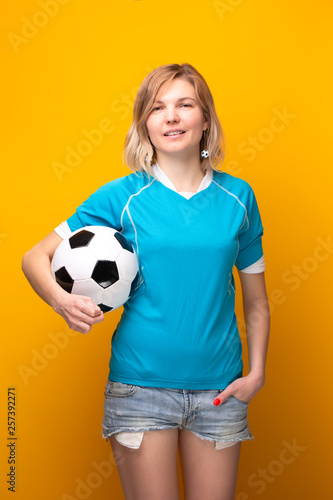 Photo of blonde with soccer ball on yellow background © nuclear_lily