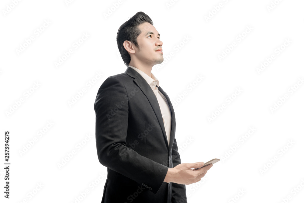 Portrait of asian businessman looking up and holding the mobile phone Portrait of asian businessman looking up and holding the mobile phone