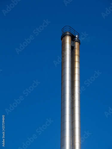 metal chimney in front of a blue sky