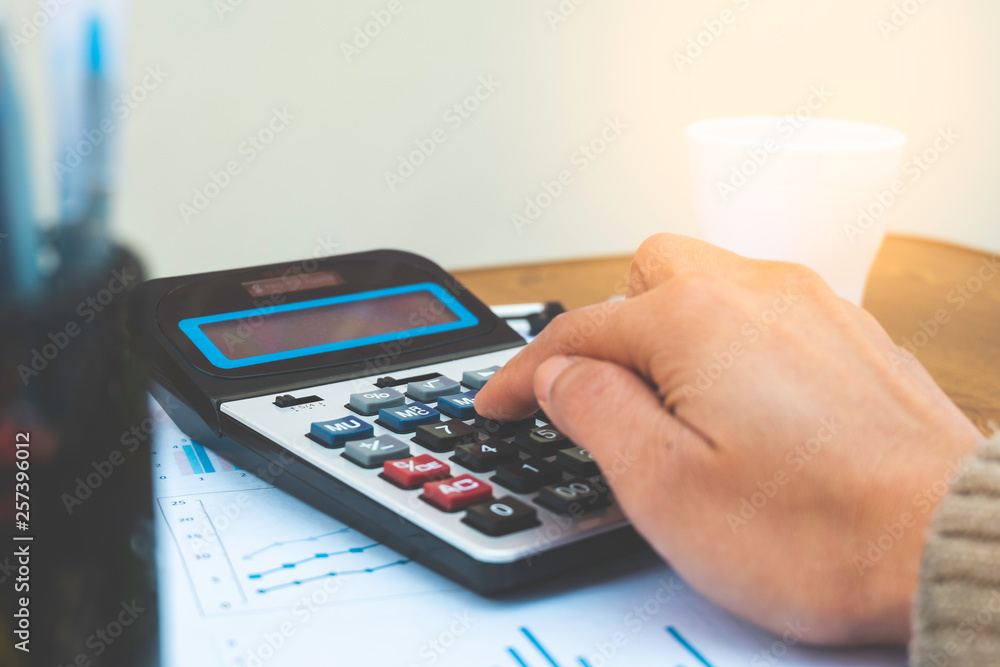 businessman working at office with using a calculator to calculate finance concept. businessman working at office with using a calculator to calculate finance concept.