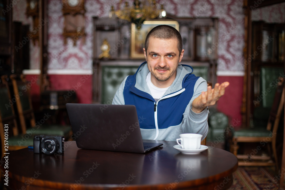 Man blogger telling something to his audience in camera Man blogger telling something to his audience in camera