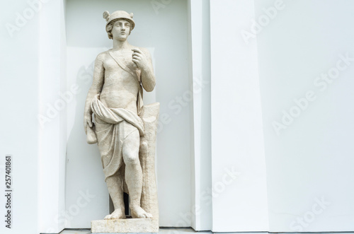statue in the portico of a building on a neutral light background