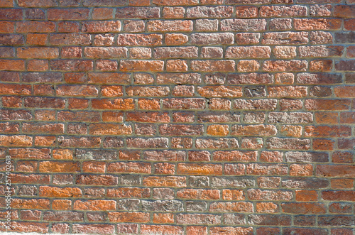 wall of red brick sunlit