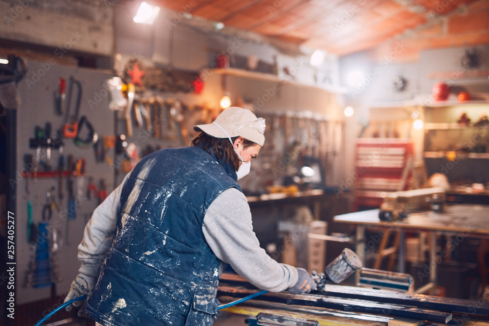Male carpenter working on old wood in a retro vintage workshop. Male carpenter working on old wood in a retro vintage workshop.