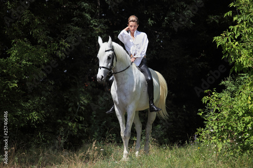 Attractive beauty equestrian girl riding bareback white horse 