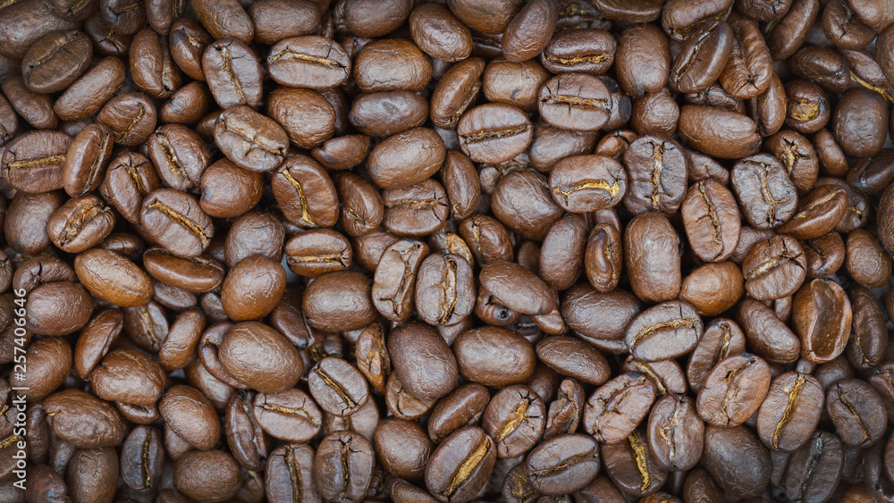 Naklejka premium Brown roasted coffee beans texture background for food and drink or agriculture concept design