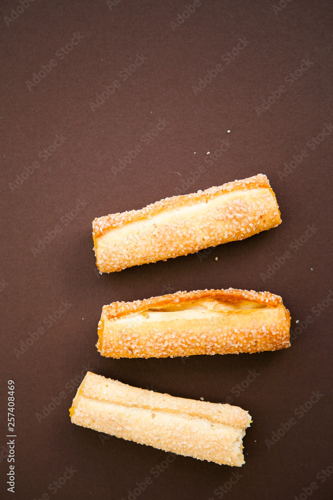 Fototapeta premium Cookies on the chocolate (dark brown) background