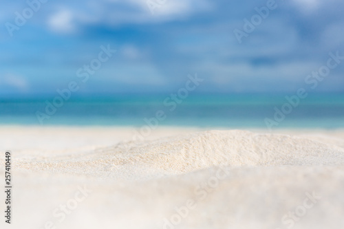 Blurred ea background with white sand and tropical landscape view. Perfect exotic beach nature. Sea sand sky concept template
