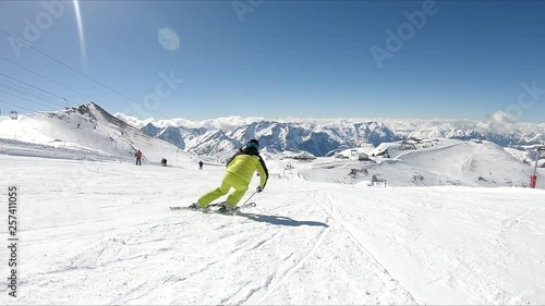Female skier go down on ski route