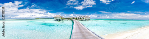 Fototapeta Naklejka Na Ścianę i Meble -  Panoramic landscape of Maldives beach. Tropical panorama, luxury water villa resort with wooden pier or jetty. Luxury travel destination background for summer holiday and vacation concept.