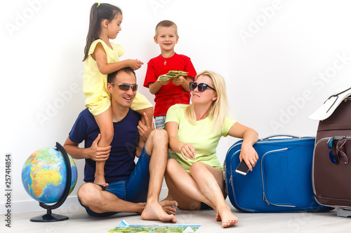 Happy family with luggage are ready to travel. Isolated on white background.