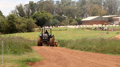 Wind mill and hay bales to atract ron a farm 