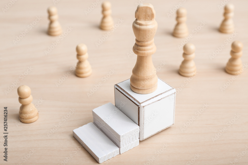 Cube with chess piece on table. Concept of career growth Cube with chess piece on table. Concept of career growth