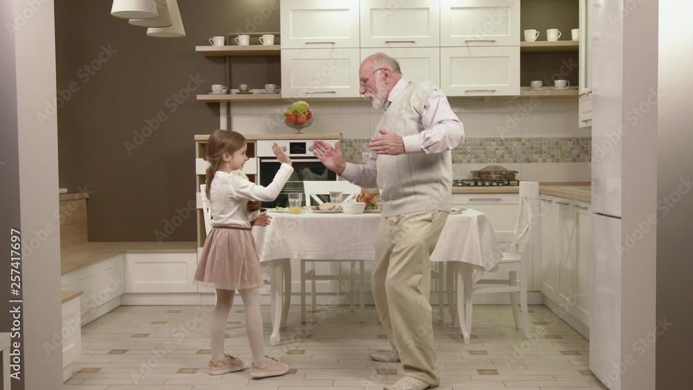 Little Girl With Her Grandfather Have Fun And Dancing Little Girl With Her Grandfather Have Fun And Dancing