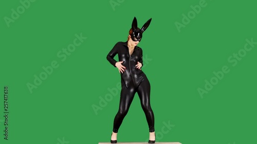 Ginger Girl Wearing Bunny Mask And Tight Leather Catsuit Dancing on Green Screen