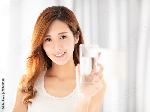 smiling beautiful young woman drinking water