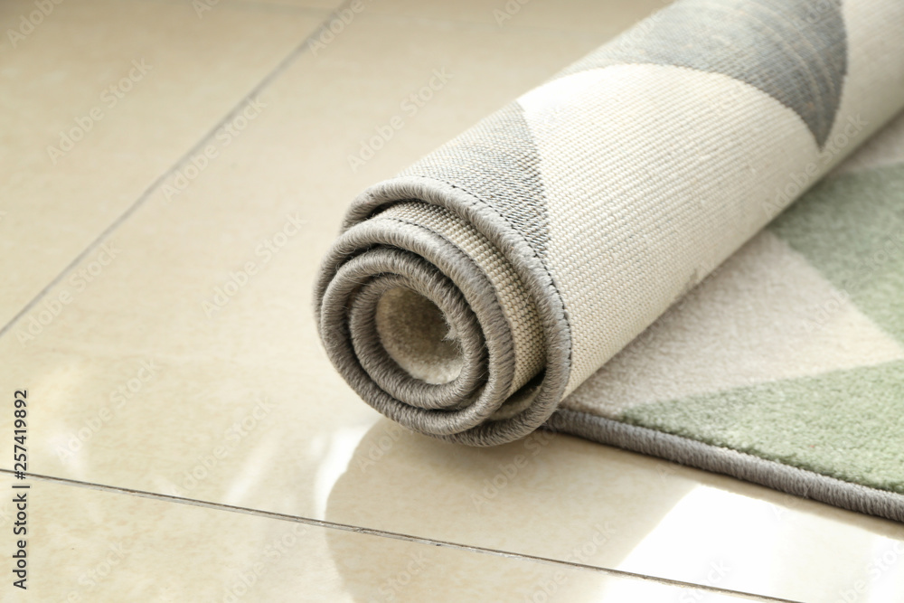 Rolled carpet on floor in room Rolled carpet on floor in room