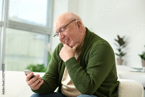 Senior man with hearing aid...