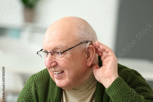 Senior man with hearing aid...