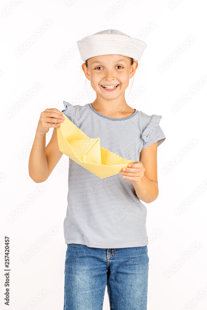 Little girl wearing a sailor costume and looking at the camera on white background. Little girl wearing a sailor costume and looking at the camera on white background.
