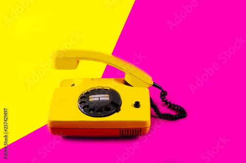 Retro vintage phone handset yellow pink red purple plastic orange disko background old style shadow 90 answer reply raised