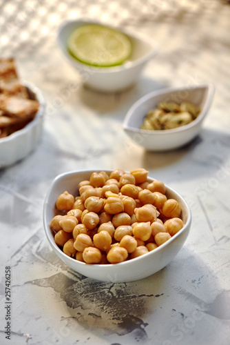 Chickpeas cooked in white bow, on the table ready