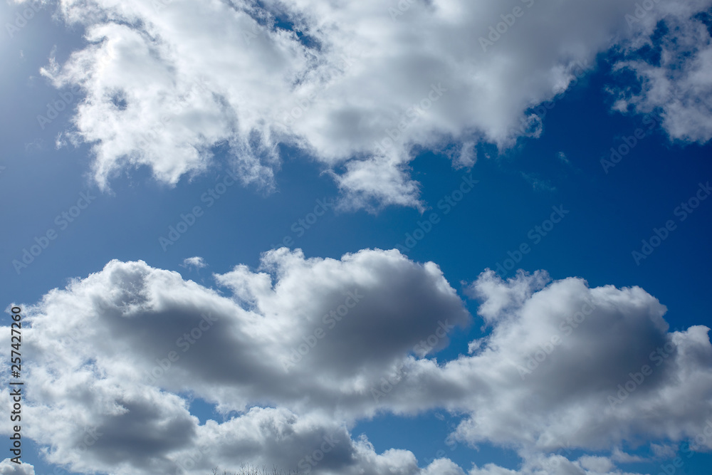 White fluffy clouds in bright blue sky minimal White fluffy clouds in bright blue sky minimal