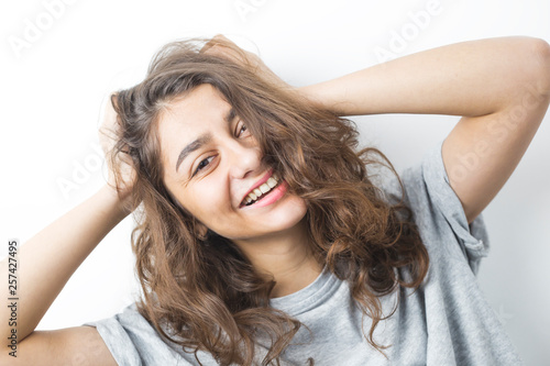 Cheerful and funny Indian girl on a white background. Positive cool happy female. Emotional young woman.