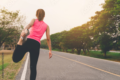 Women warm up exercises before running jogging during sunset at road park © Kanpob