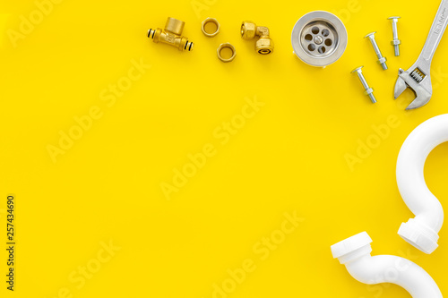 Plumber work with instruments, tools and gear on yellow background top view mockup