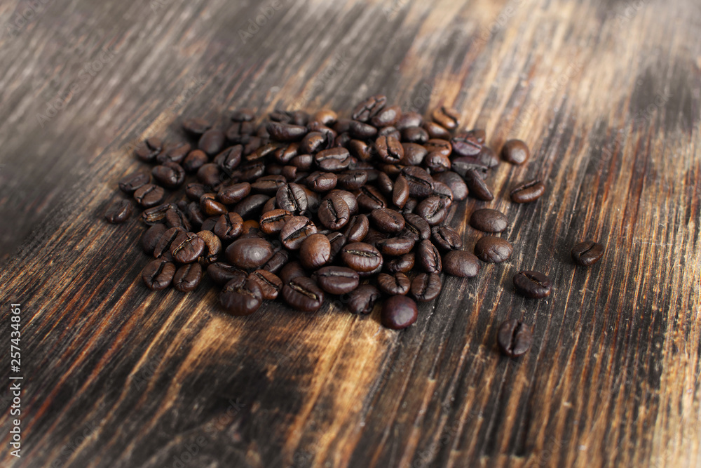 Brown arabica coffee beans on a wooden board. Brown arabica coffee beans on a wooden board.