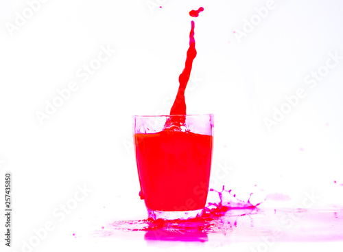 Red Juice splash in glass isolated on white background