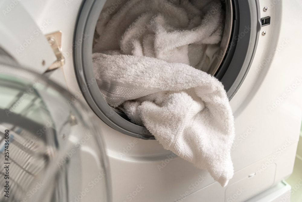 A close up washing machine with clothes A close up washing machine with clothes