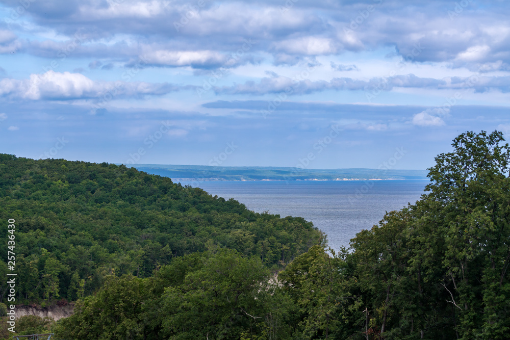 Landscape with river and green forests.