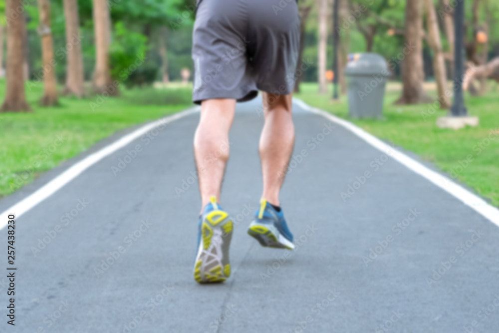blur Young athlete man with running shoes in the park outdoor, male runner jogging on the road outside, asian Fitness walking and exercise on footpath in morning. wellness and sport concepts blur Young athlete man with running shoes in the park outdoor, male runner jogging on the road outside, asian Fitness walking and exercise on footpath in morning. wellness and sport concepts