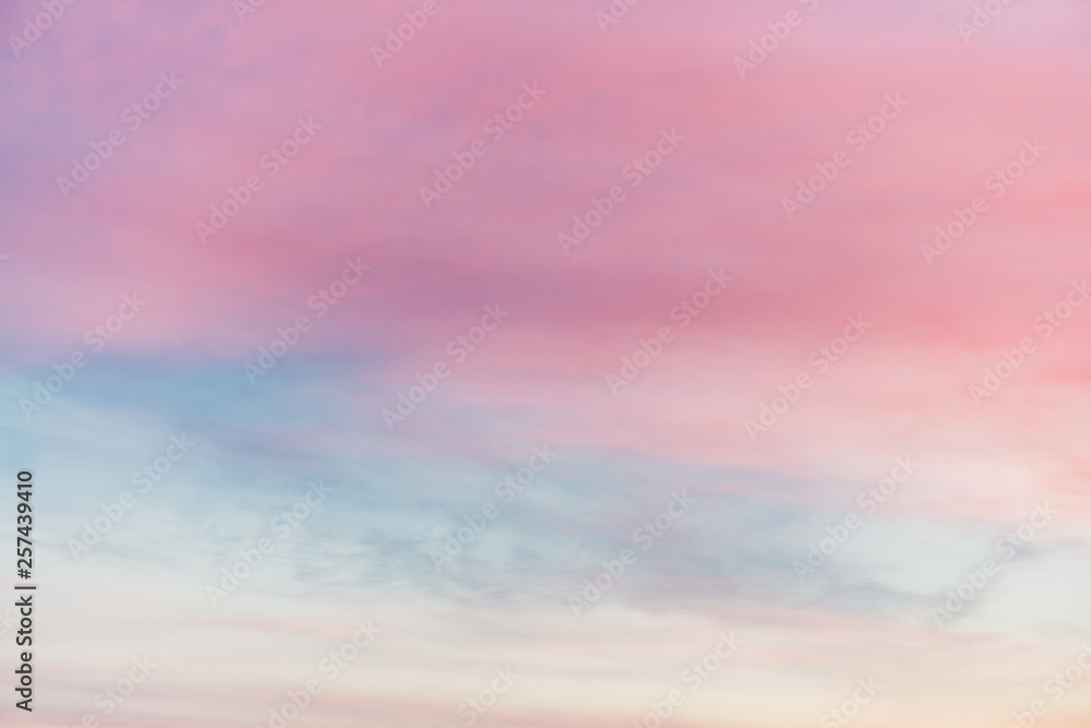 Sunset sky with multicolor light clouds. Colorful smooth sky gradient. Natural background of sunrise. Amazing heaven at morning. Slightly cloudy evening atmosphere. Wonderful weather. Pink dawn clouds