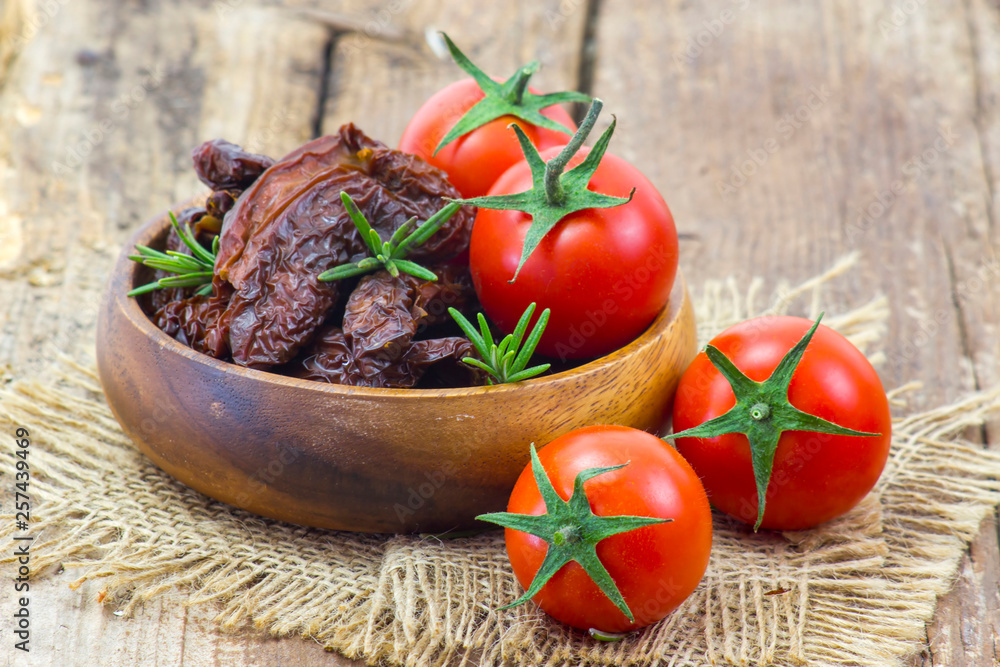 fresh and dried tomatoes on wooden background fresh and dried tomatoes on wooden background