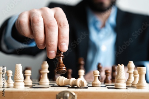 Wallpaper Mural hand of businessman moving chess figure in competition success play. strategy, management or leadership concept. Torontodigital.ca
