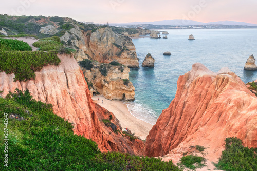 evening seascape, red quaint rocks, beaches, and islands on the coast of the atlantic ocean in the city of Lagos in Portugal