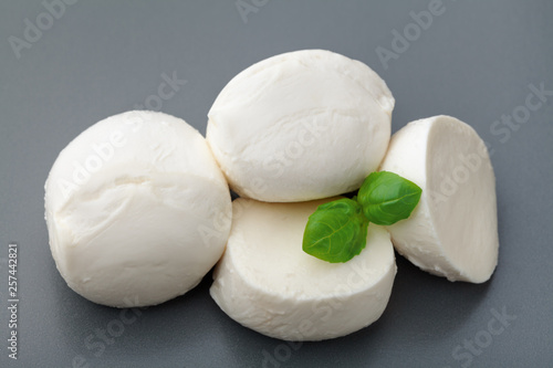 Mozzarella cheese with basil on stone table. Natural italian dairy product.