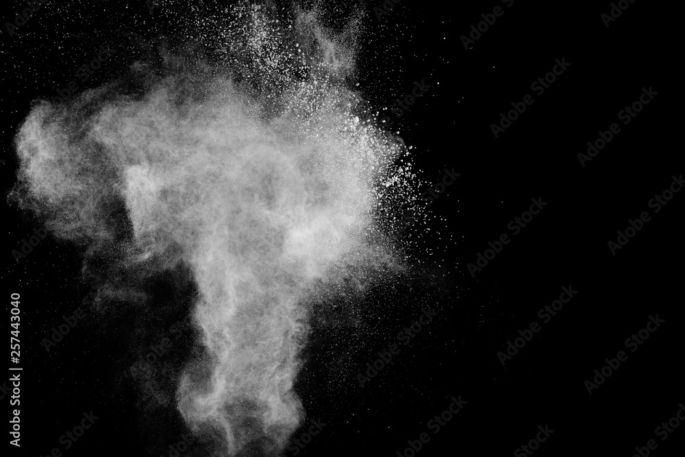 White powder explosion.Freeze motion of white dust particles on black background.