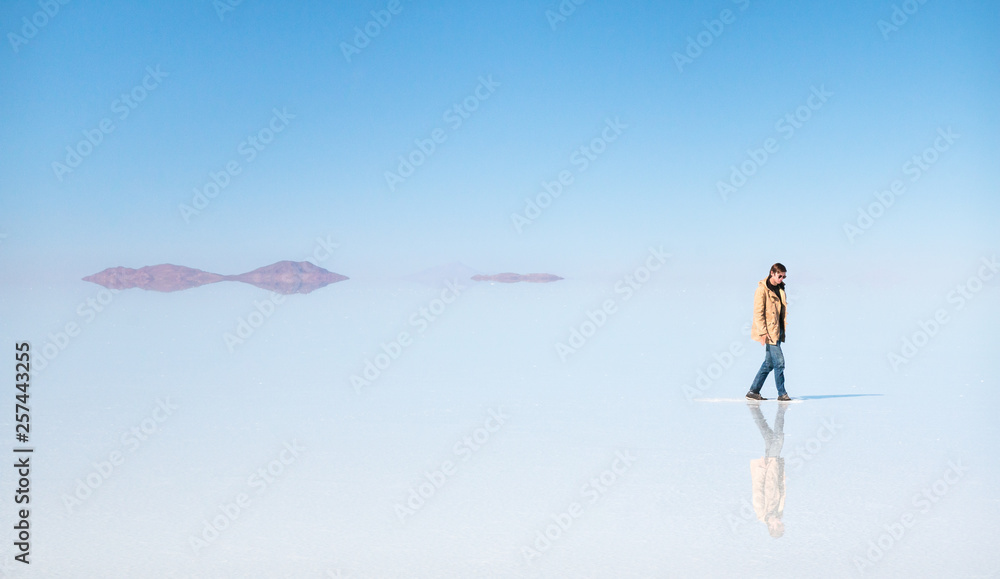 Man walking on the water in Uyuni Man walking on the water in Uyuni