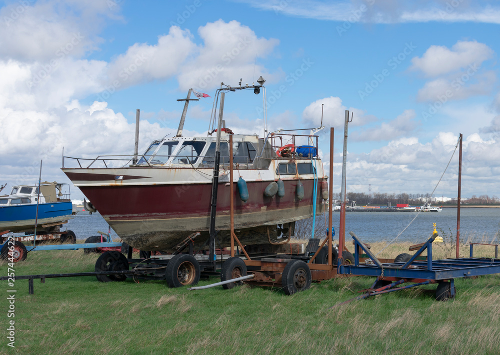 Old boat on the shore ready for restoration at the port of Doel Old boat on the shore ready for restoration at the port of Doel
