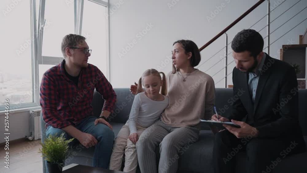 Woman and man is discussing with lawyer and agent annual payment for home mortgage. Woman and man is discussing with lawyer and agent annual payment for home mortgage.